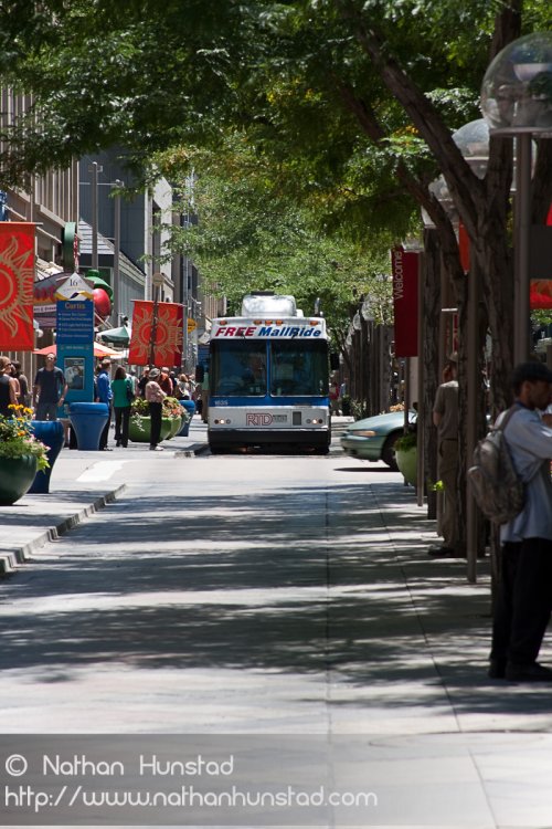 A bus drives down the 16th Street Mall in downtown Denver, CO
